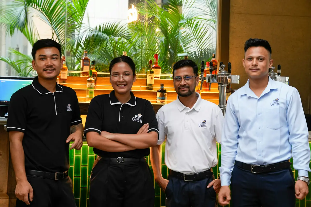 A uniformed service team standing together and smiling